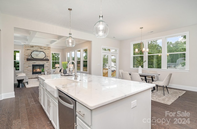 kitchen with white cabinetry, a healthy amount of sunlight, dark hardwood / wood-style flooring, stainless steel dishwasher, and an island with sink