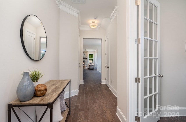 hall featuring dark wood-type flooring and crown molding