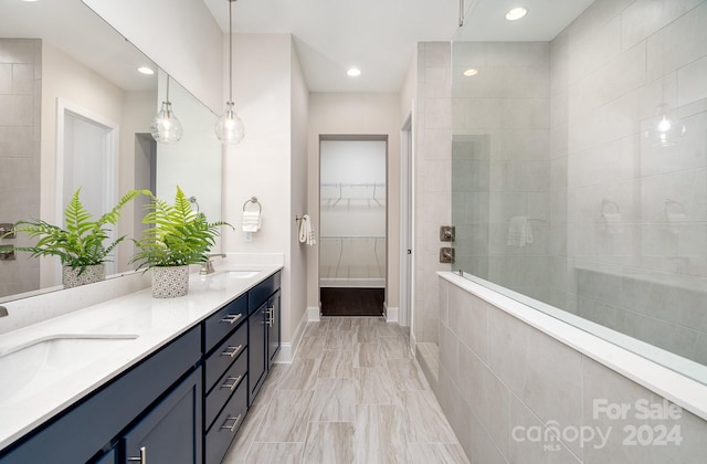 bathroom with vanity and tiled shower