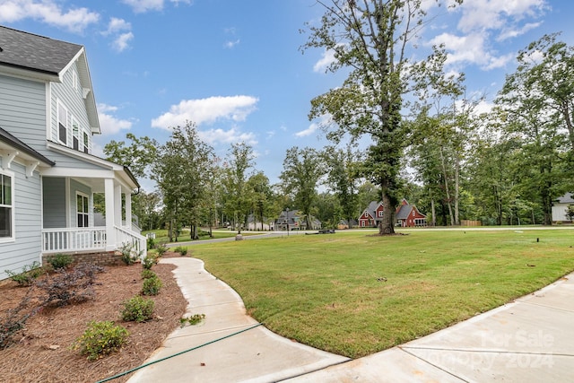 view of yard with covered porch