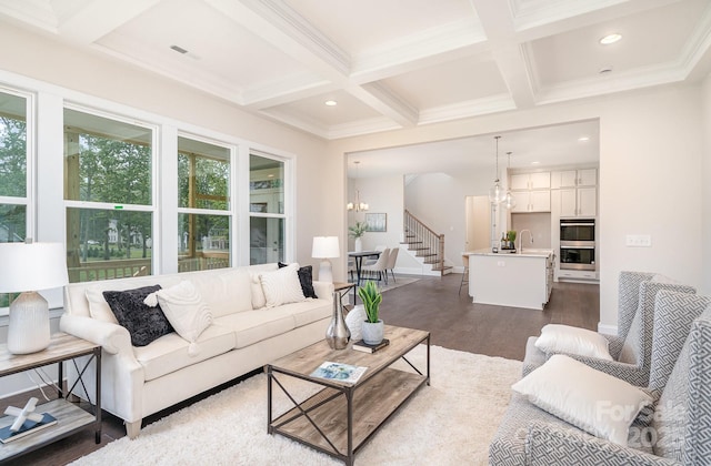 living room featuring recessed lighting, a notable chandelier, dark wood-style flooring, coffered ceiling, and beamed ceiling