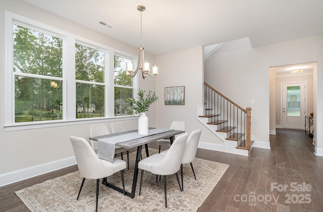 dining space featuring dark wood-style flooring, visible vents, stairway, and baseboards