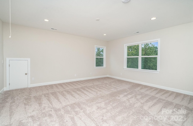 carpeted spare room with attic access, recessed lighting, visible vents, and baseboards