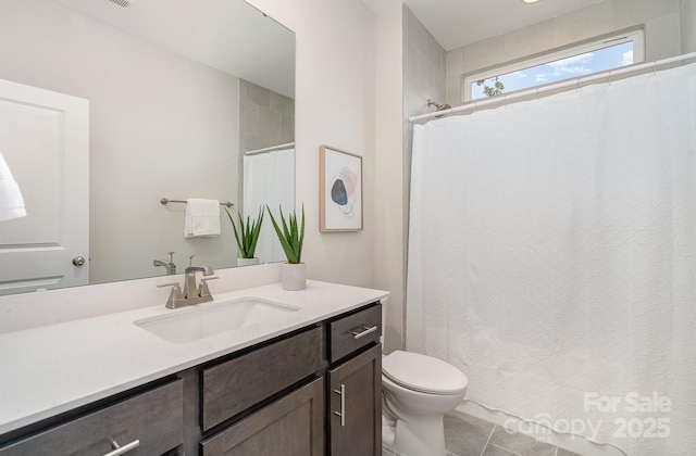 full bath featuring toilet, a shower with shower curtain, and vanity