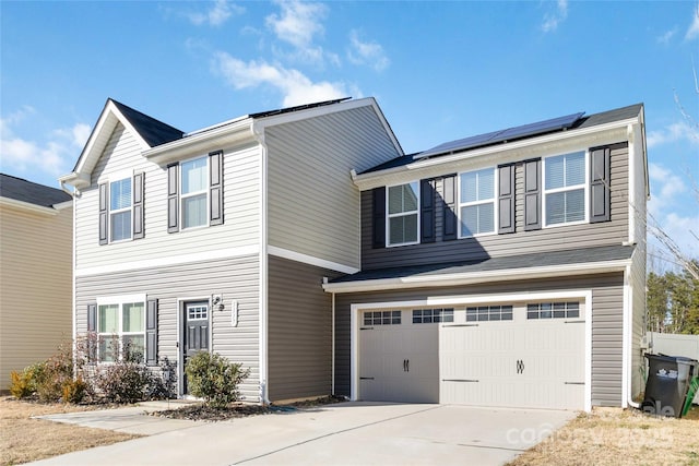 view of front of home with solar panels and a garage