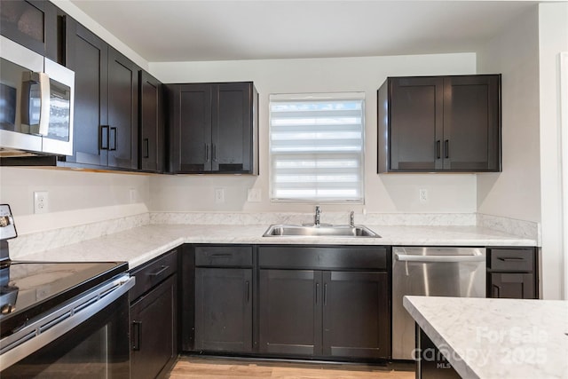 kitchen with sink and appliances with stainless steel finishes