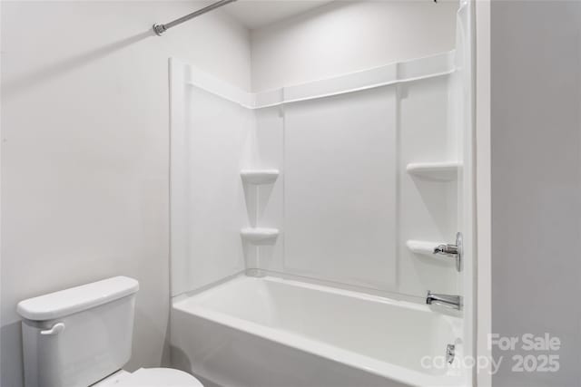 bathroom featuring shower / washtub combination and toilet