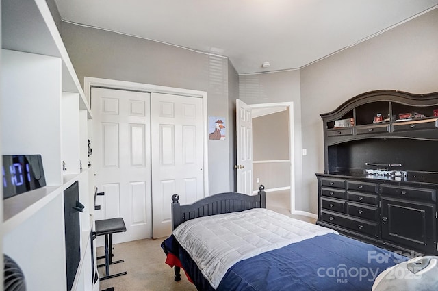 bedroom featuring light carpet and a closet