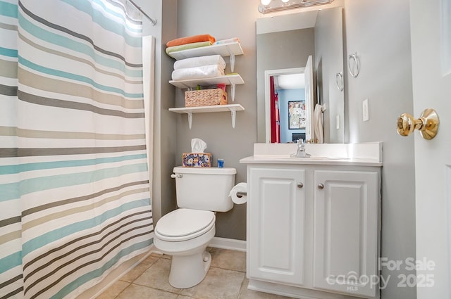 bathroom featuring tile patterned floors, a shower with curtain, toilet, and vanity