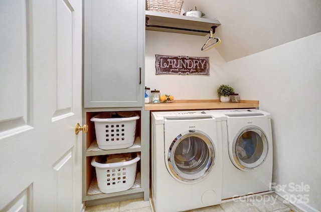 laundry area with cabinets, washing machine and dryer, and light tile patterned floors