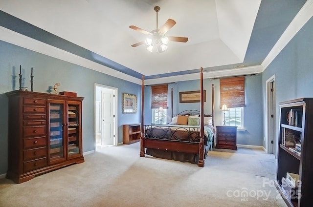 bedroom with a tray ceiling, ceiling fan, and light colored carpet