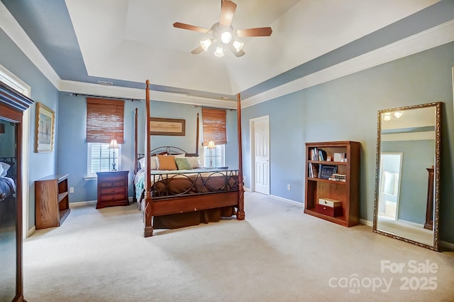 bedroom featuring ceiling fan, lofted ceiling, light carpet, and a tray ceiling