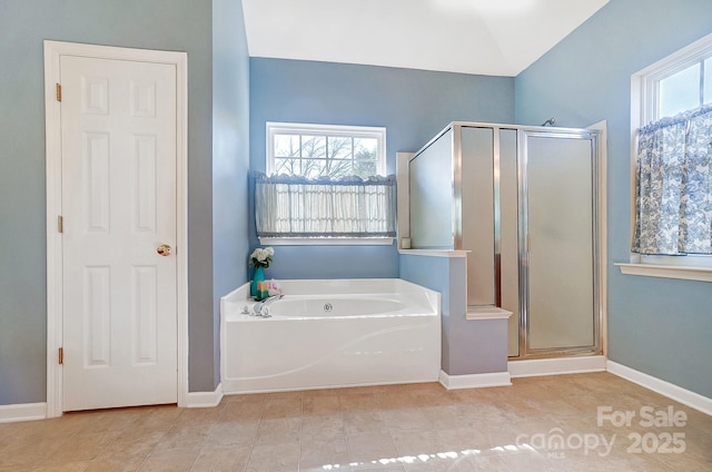 bathroom featuring tile patterned flooring and separate shower and tub