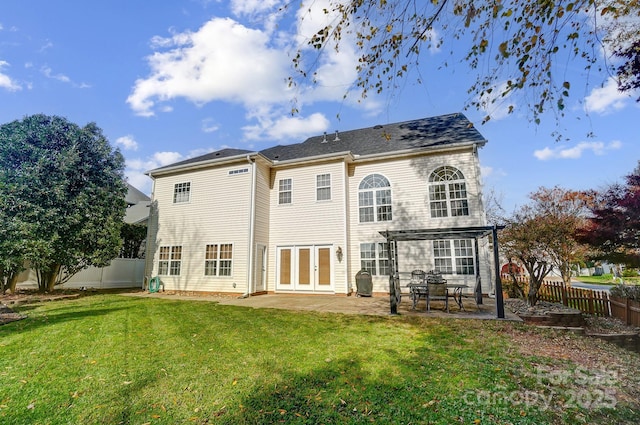 back of house with a lawn, a patio area, and french doors