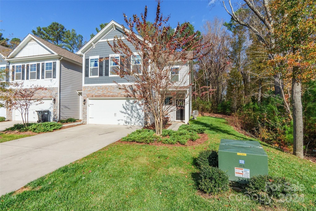 view of front of house featuring a garage and a front yard