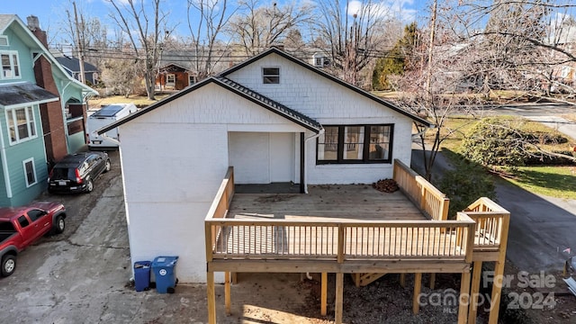 back of house with a wooden deck