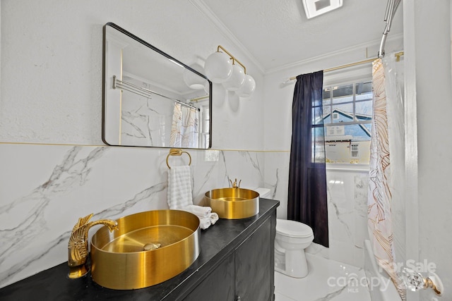 bathroom with tasteful backsplash, vanity, a textured ceiling, crown molding, and toilet