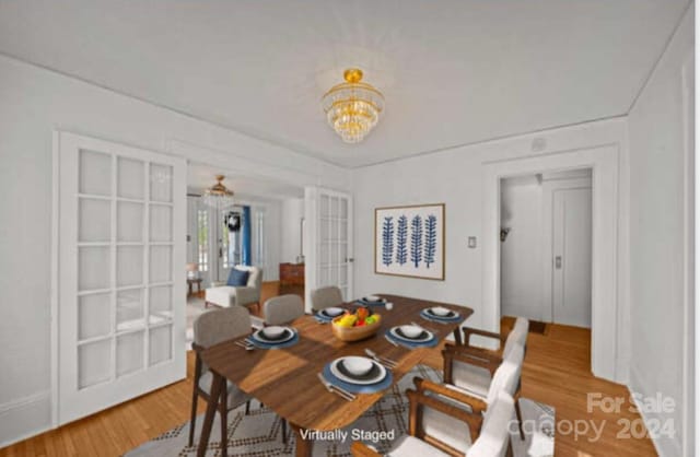 dining space featuring a notable chandelier, wood-type flooring, and french doors