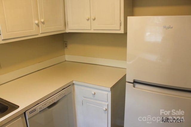 kitchen with white cabinets and white appliances