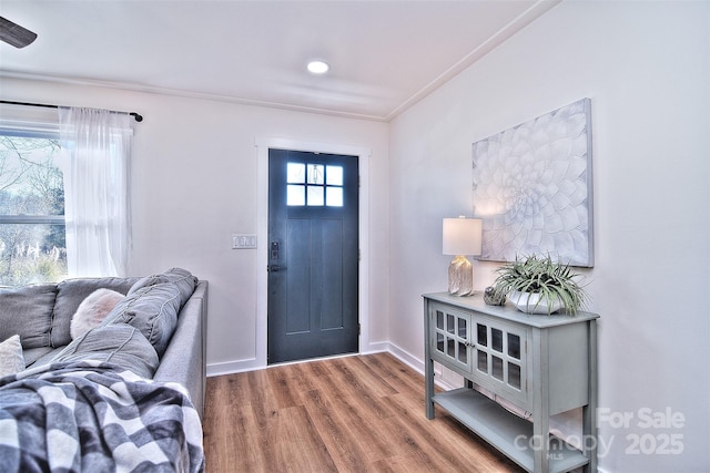 foyer with hardwood / wood-style floors and ornamental molding