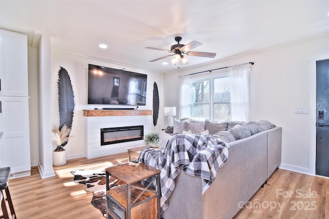 living room featuring light wood-type flooring and ceiling fan