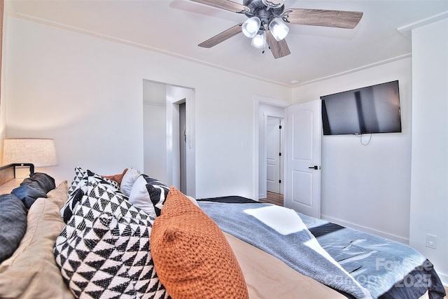 bedroom featuring ceiling fan and crown molding