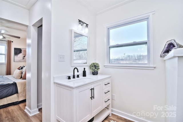 bathroom featuring ceiling fan, hardwood / wood-style floors, and vanity