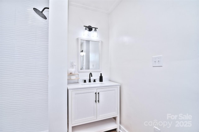 bathroom featuring a tile shower and vanity