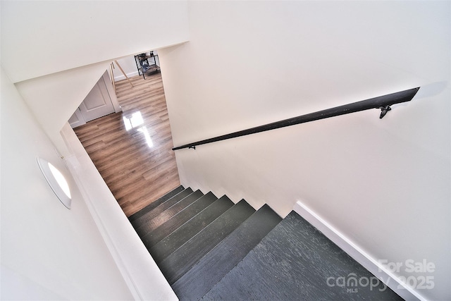 stairway with hardwood / wood-style flooring