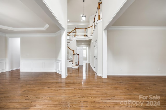 foyer featuring hardwood / wood-style floors and crown molding