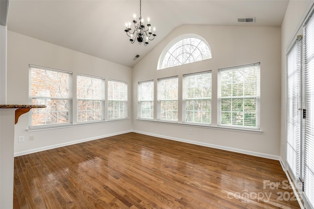 unfurnished sunroom with lofted ceiling and a chandelier