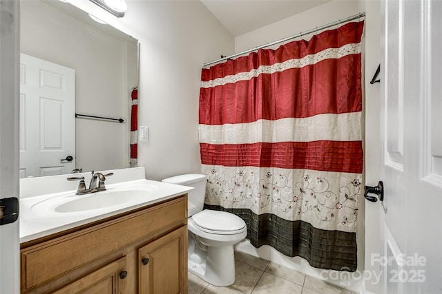 bathroom featuring tile patterned flooring, vanity, walk in shower, and toilet