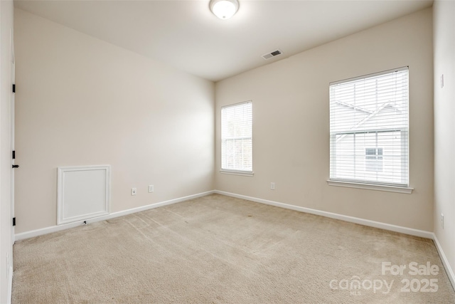 unfurnished room with light carpet