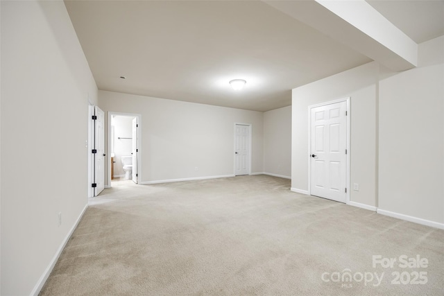 unfurnished room featuring light colored carpet