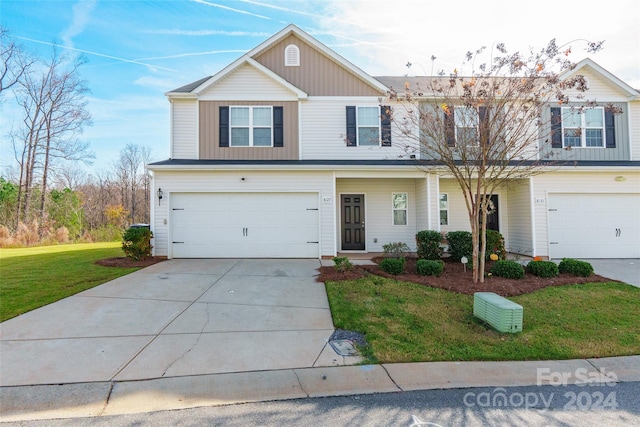 front of property featuring a front yard and a garage