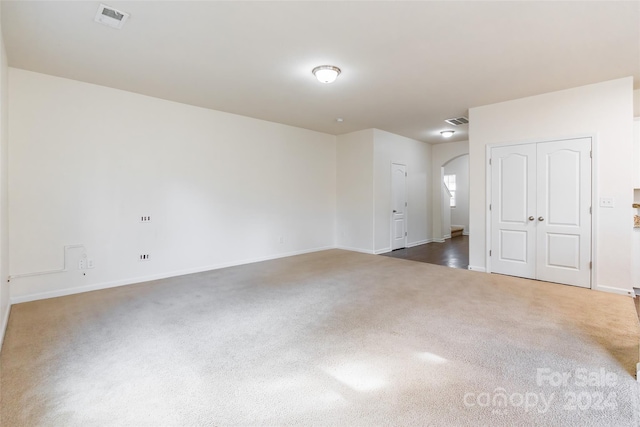 empty room with dark colored carpet