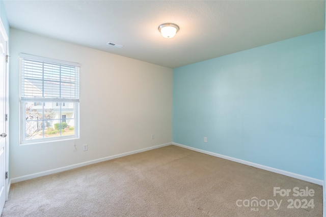 empty room featuring light colored carpet