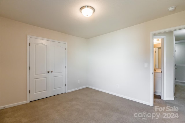 unfurnished bedroom featuring a closet and carpet