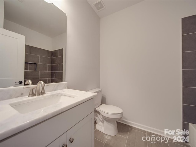 bathroom with tile patterned floors, vanity, and toilet