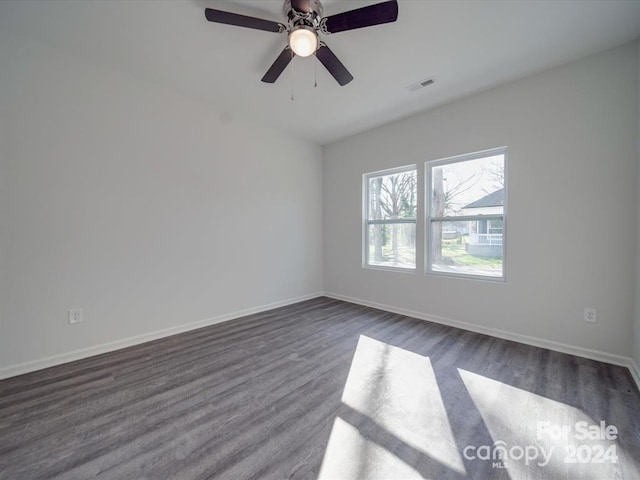 empty room with ceiling fan and dark wood-type flooring