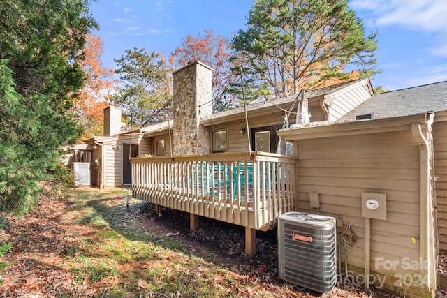 rear view of house with a deck and central AC unit