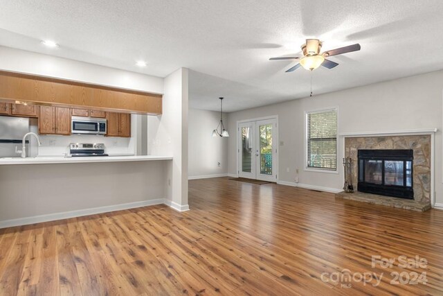 924 Cranberry Cir Unit 50-C, Fort Mill, SC 29715 - kitchen featuring stainless steel appliances, brown cabinets, light countertops, wood finished floors, and ceiling fan