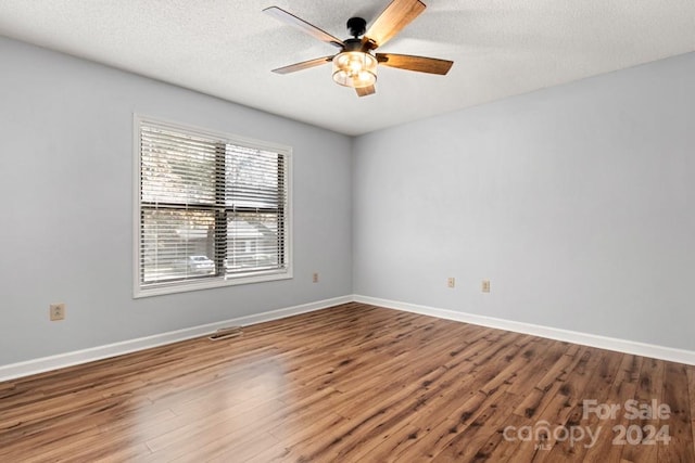 spare room with wood-type flooring, a textured ceiling, and ceiling fan