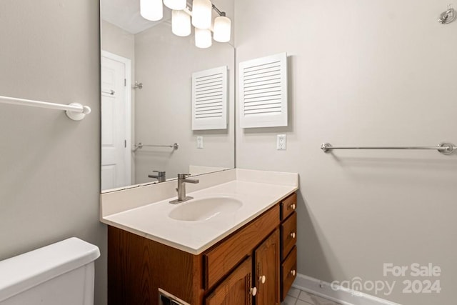 bathroom with tile patterned floors, vanity, and toilet