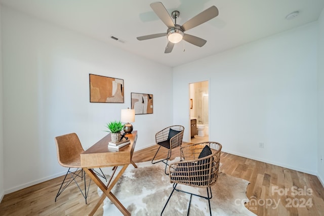 home office with ceiling fan and light hardwood / wood-style flooring