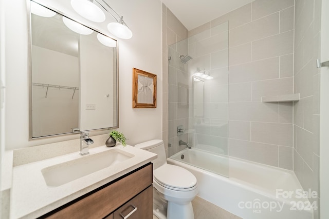 full bathroom with vanity, tiled shower / bath combo, and toilet