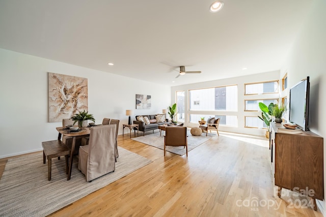 living room featuring light hardwood / wood-style flooring and ceiling fan