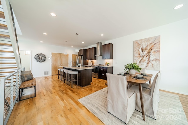 dining area featuring light hardwood / wood-style flooring and sink