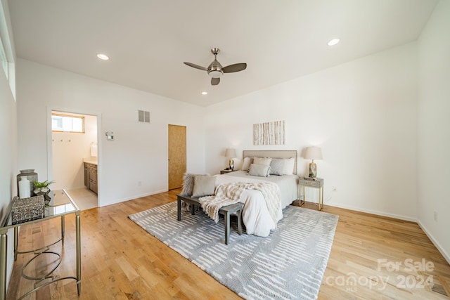 bedroom featuring ensuite bath, ceiling fan, and light hardwood / wood-style flooring