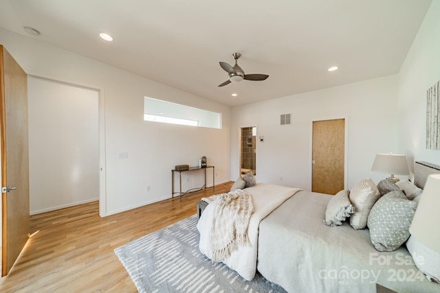 bedroom with ceiling fan and light hardwood / wood-style floors